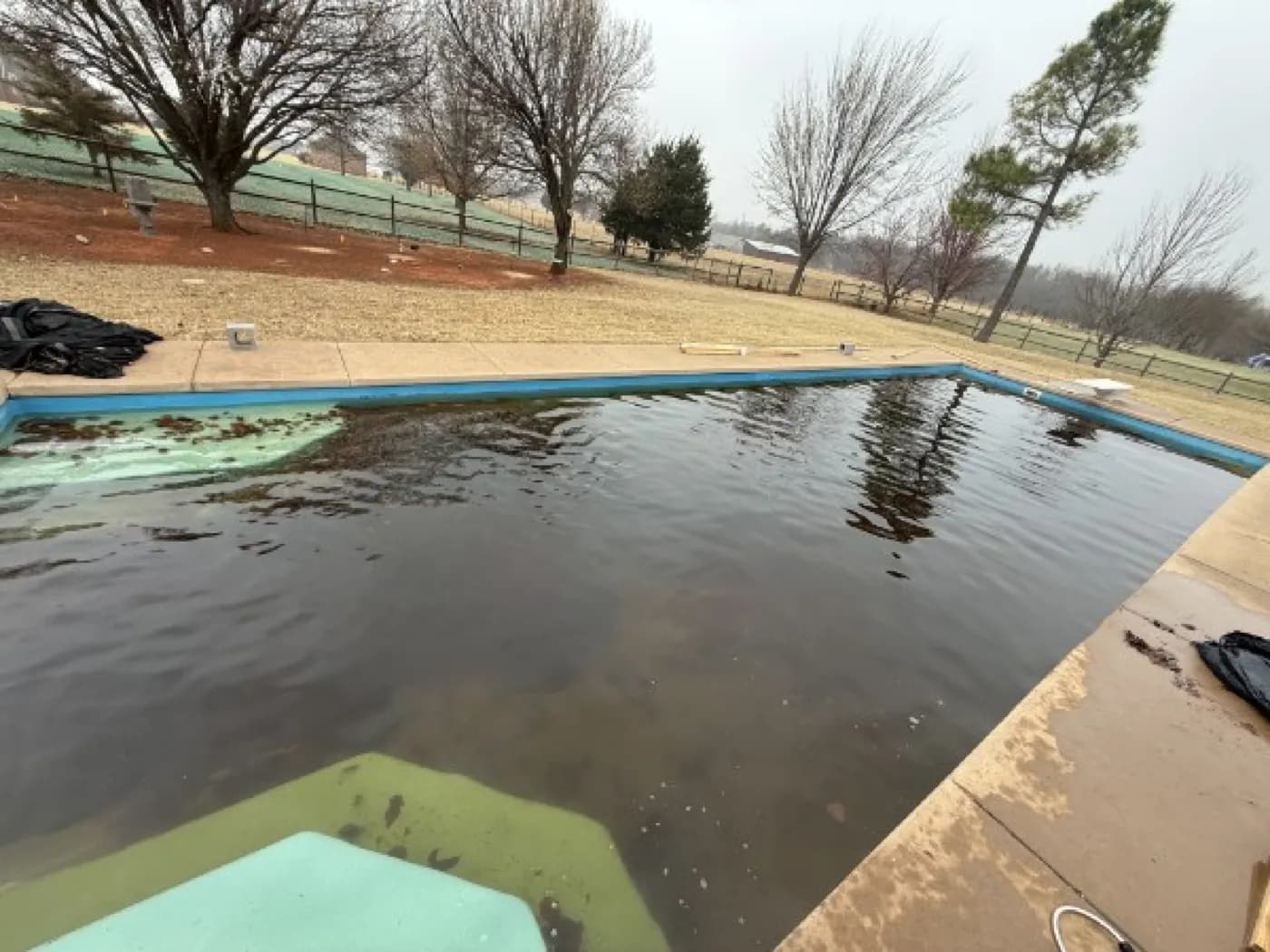 Dark, murky pool water before recovery at an Oklahoma City metro home